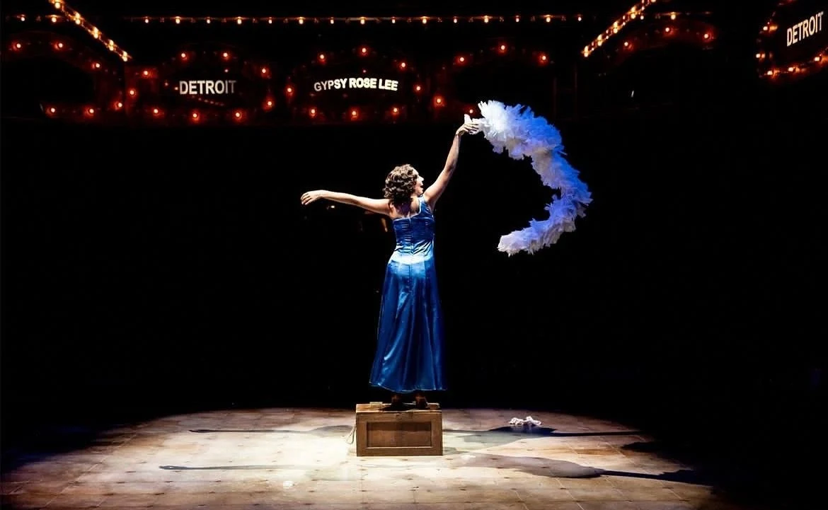 Lauren performing as Louise under stage lights in Gypsy