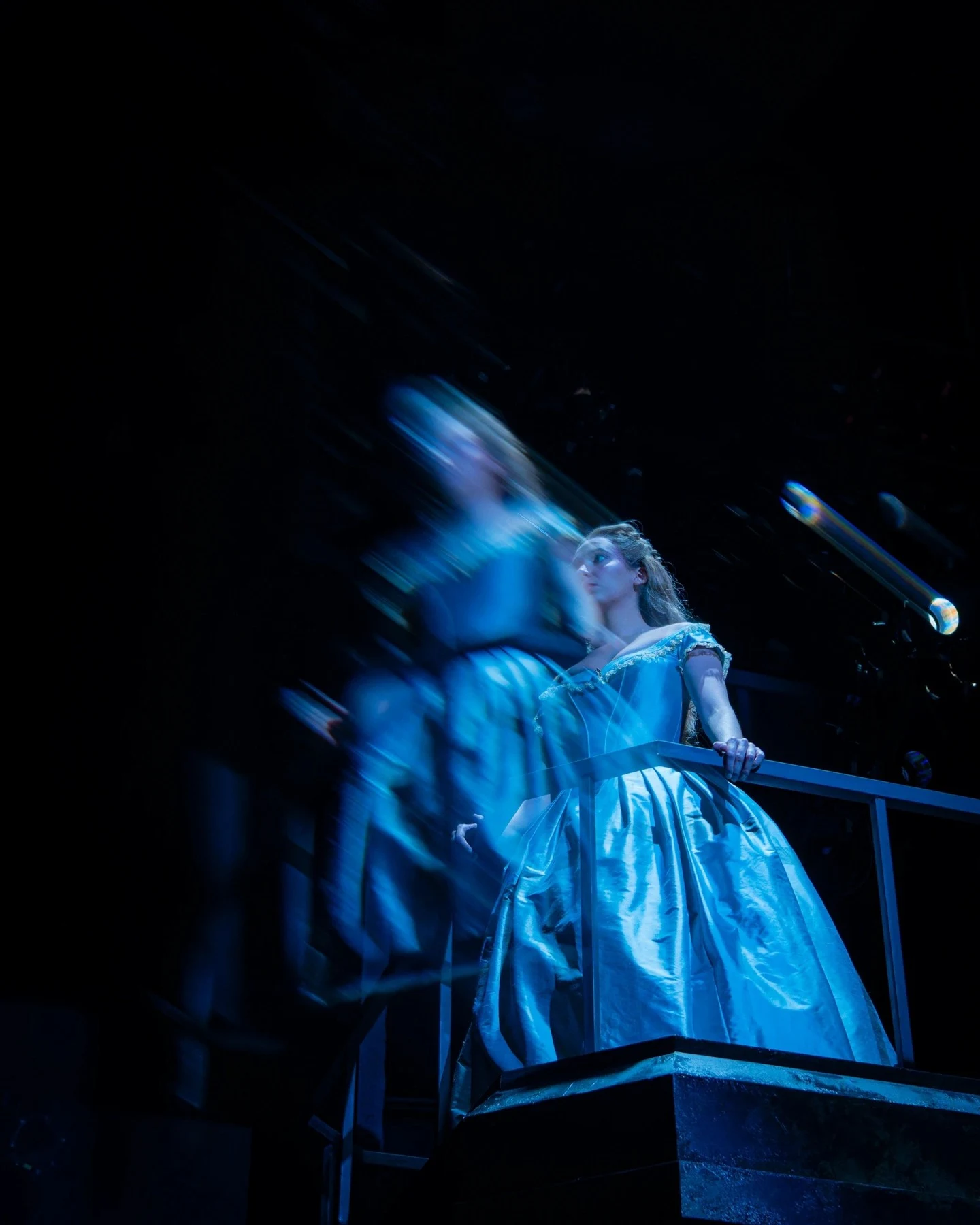 Lauren as Johanna in Sweeney Todd, illuminated by blue theatrical light